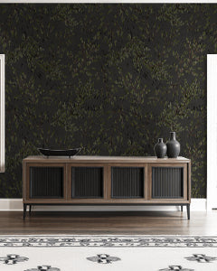 Charcoal leaf branch wallpaper in modern living room with wooden sideboard.