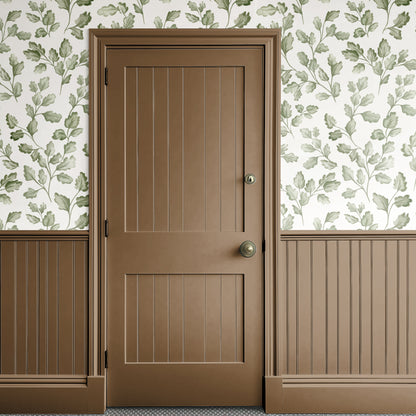 Brown door with gold handle against a floral wallpapered wall