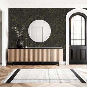 Charcoal wallpaper with green leaf branches in modern hallway setting.