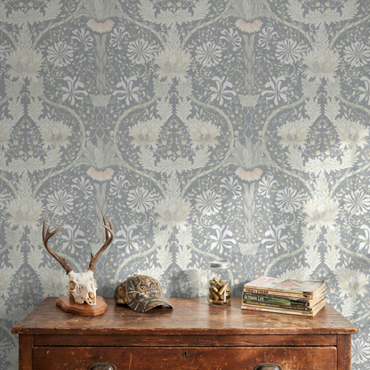 Floral wallpaper with honeysuckle and daisies in cool tones above a rustic wooden dresser.