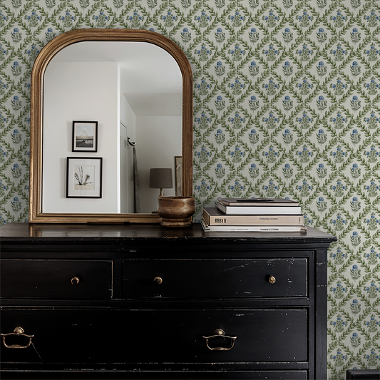 Ivory wallpaper with green lattice and blue blossoms in a vintage room setting.
