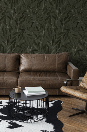Brown leather sofa in a room with dark leaf-patterned wallpaper.